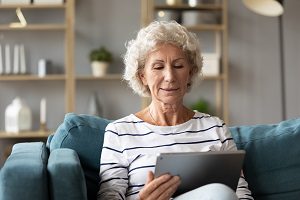 Senior using tablet at home