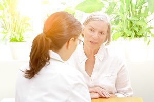 Image of older woman talking with audiologist.