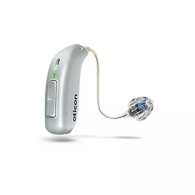 Silver behind-the-ear hearing aid with thin wire and clear dome receiver on white background